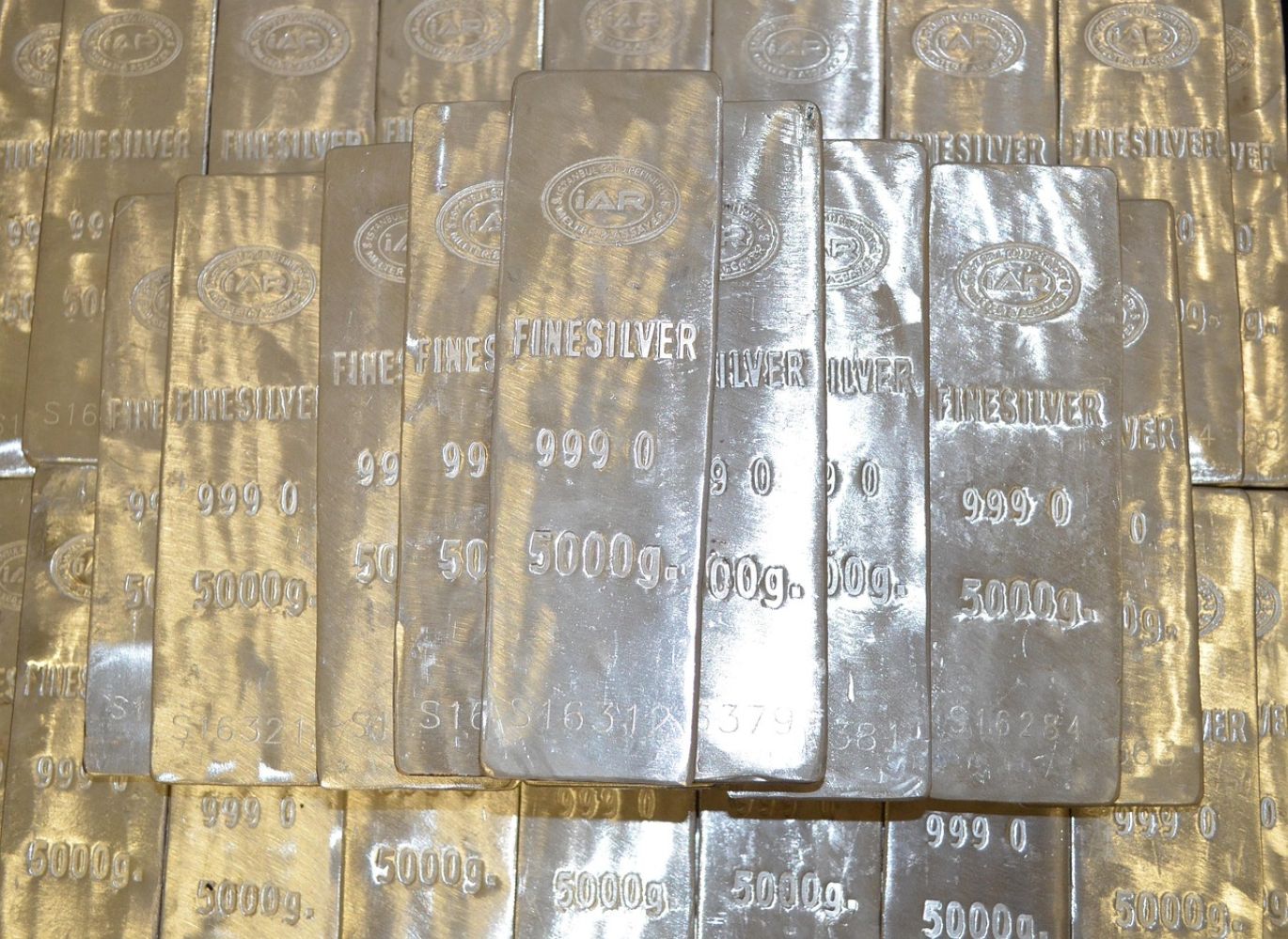 Close-up of Americas Gold And Silver bars and coins, representing precious metals trading.
