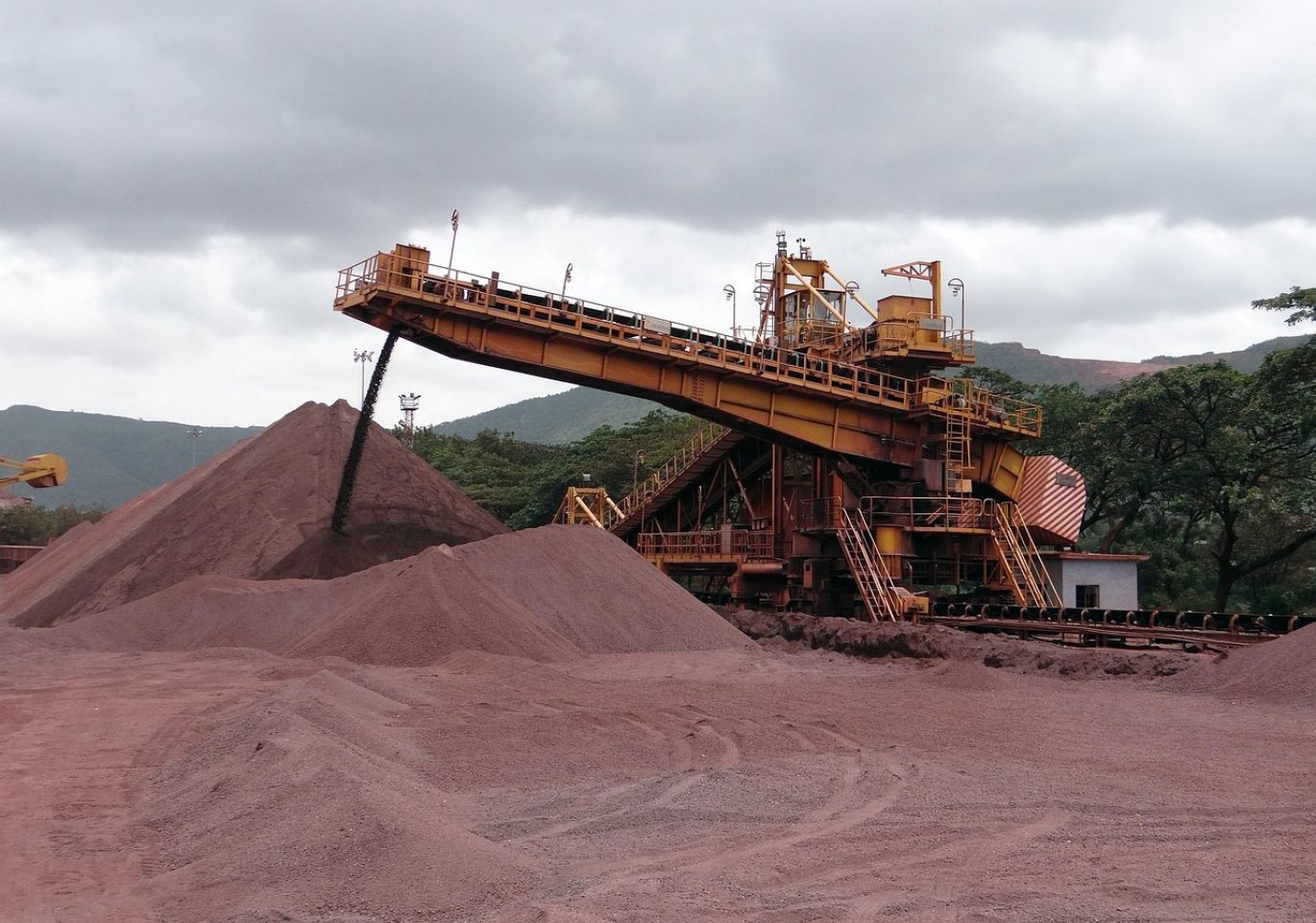 Close-up view of iron ore concentrate being processed in an industrial plant for beneficiation of iron ore.