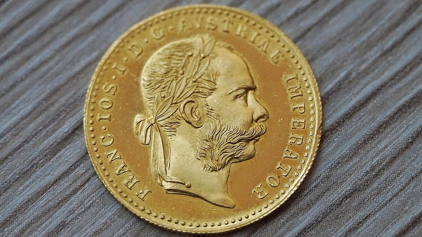Close-up of gleaming gold bars and silver coins, symbolizing the Best Precious Metal To Invest In.