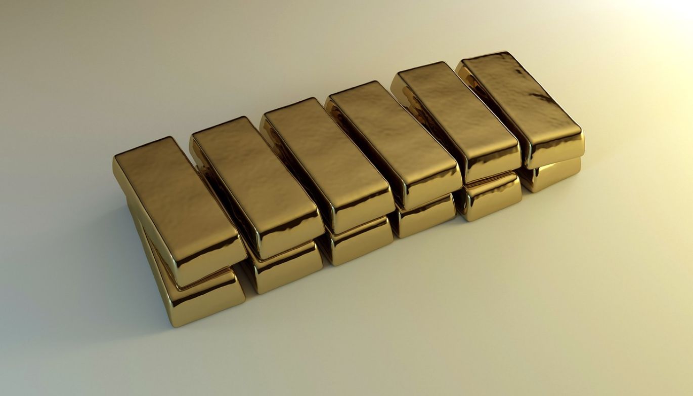 Stack of polished Bullion Oro gold ingots, representing investment and industrial value.