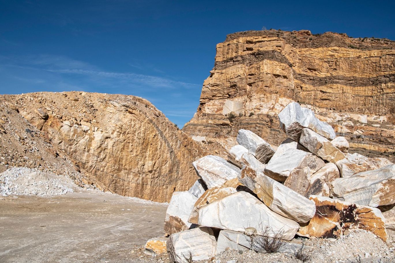 Pile of feldspar mineral rocks at a quarry, representing Feldspar Suppliers