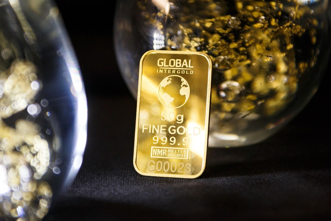 Gold bars representing the Gold Price Nymex, with abstract market data overlay.