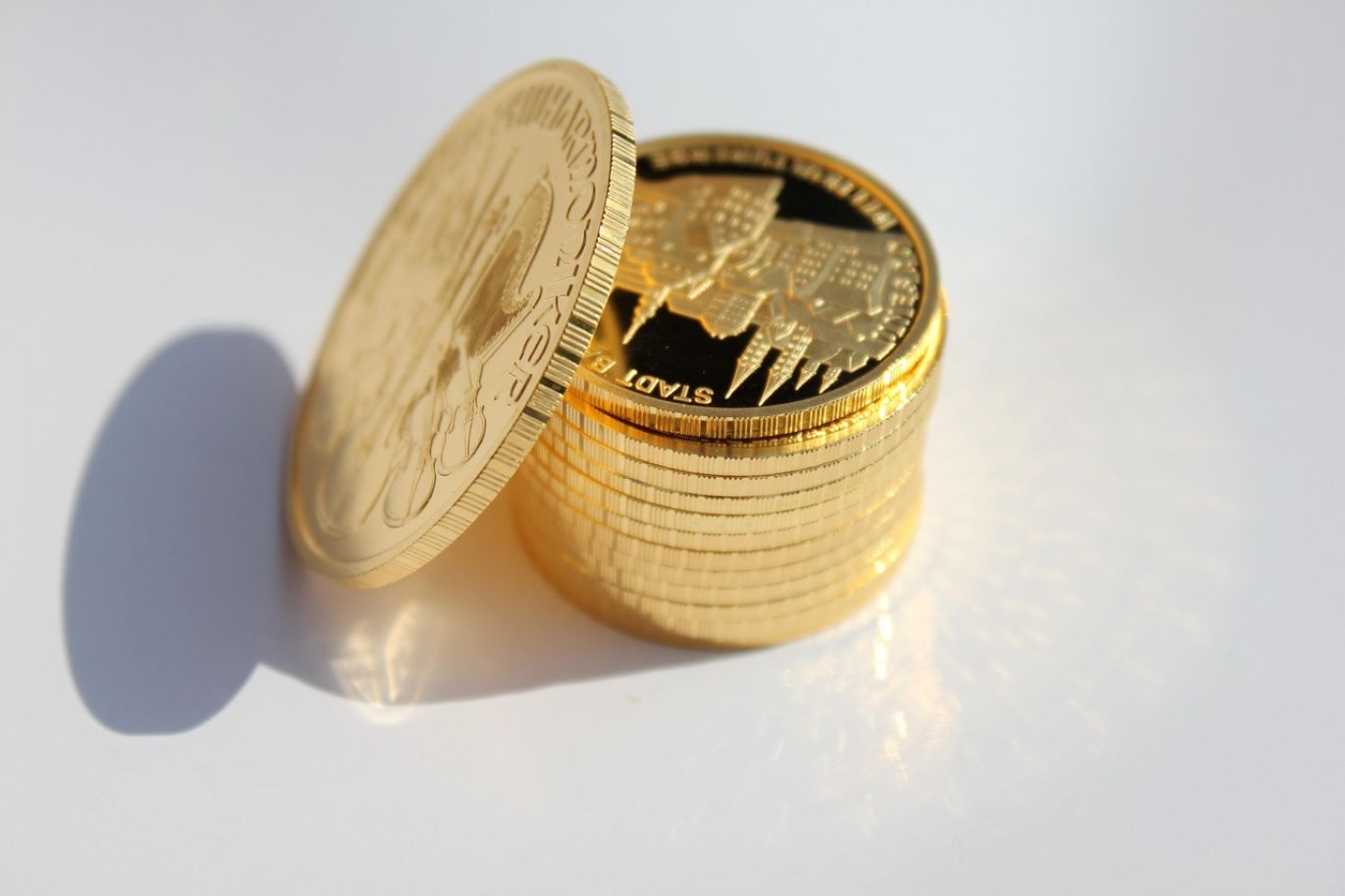A stack of Jm Bullion Gold Coins, representing secure investment and wealth, offered by Summit Gold Resources in Kenya.