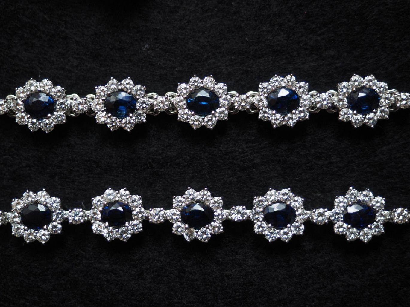 A collection of unpolished, loose sapphires in various shades of blue, ready for wholesale purchase from Summit Gold Resources.