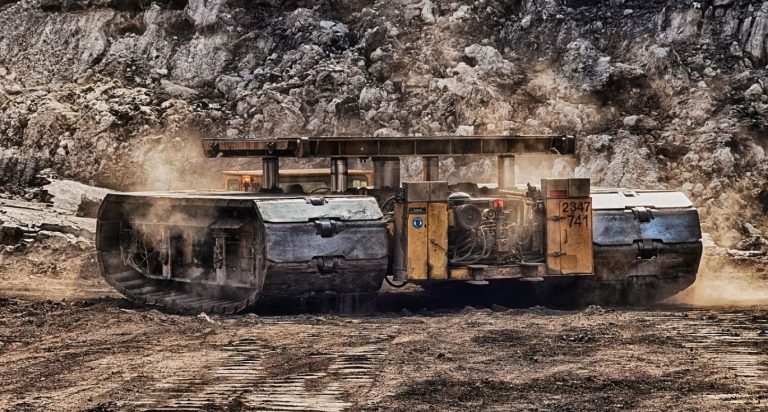 Miner holding raw materials in a mine in Kenya, representing Summit Gold Resources's mining raw materials services.