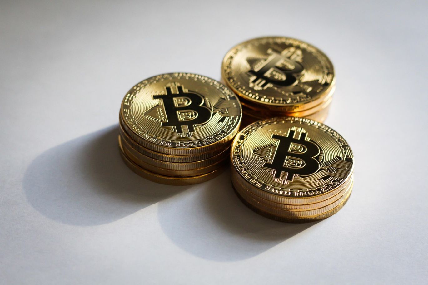 Pile of gold coins with Summit Gold Resources logo subtly integrated