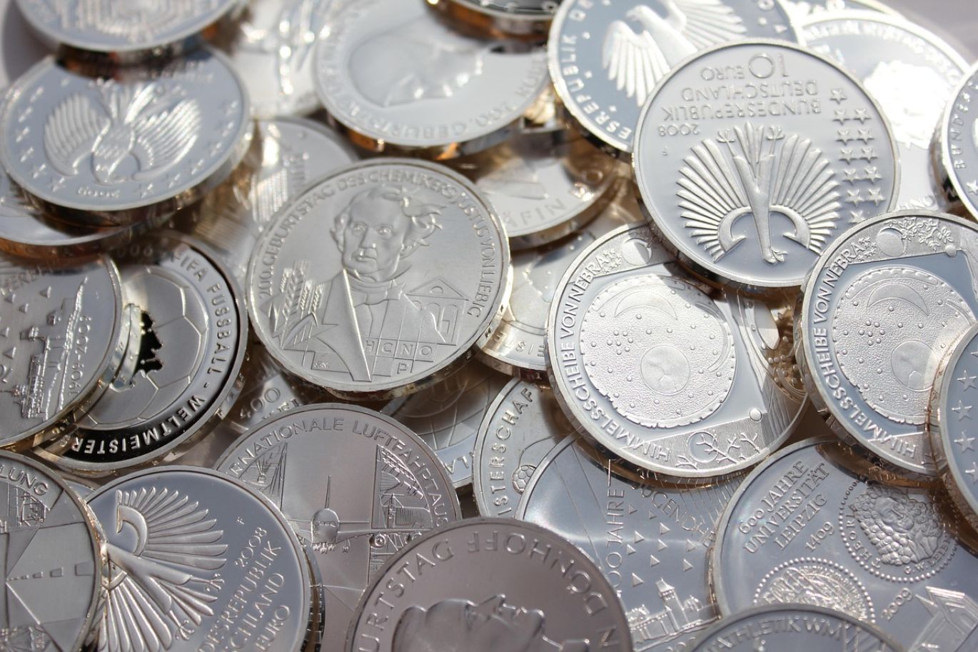 Close-up of shiny silver coins, representing an opportunity to purchase silver coins from Summit Gold Resources in Kenya.
